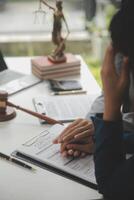 Lawyer, legal advisor, businessman brainstorming information on agreement details Business contracts in legal processing books for accuracy in contract documents. joint financial investment. photo