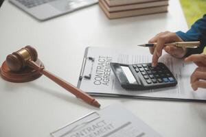 Lawyer, legal advisor, businessman brainstorming information on agreement details Business contracts in legal processing books for accuracy in contract documents. joint financial investment. photo