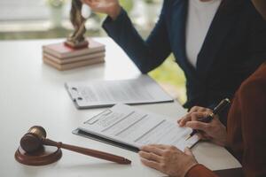 Lawyer, legal advisor, businessman brainstorming information on agreement details Business contracts in legal processing books for accuracy in contract documents. joint financial investment. photo