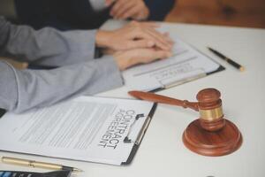 Lawyer, legal advisor, businessman brainstorming information on agreement details Business contracts in legal processing books for accuracy in contract documents. joint financial investment. photo