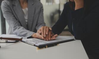 Lawyer, legal advisor, businessman brainstorming information on agreement details Business contracts in legal processing books for accuracy in contract documents. joint financial investment. photo