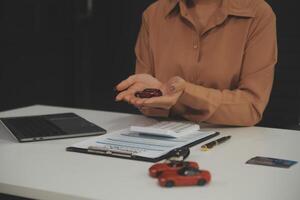 Insurance officers hand over the car keys after the tenant. have signed an auto insurance document or a lease or agreement document Buying or selling a new or used car with a car photo