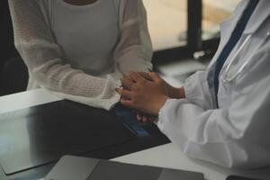 Asian female doctor giving hope and encourage to stressed woman patient at hospital. Smiling doctor woman touching on patient shoulder to support take care and helping . Supported and Encouraged photo