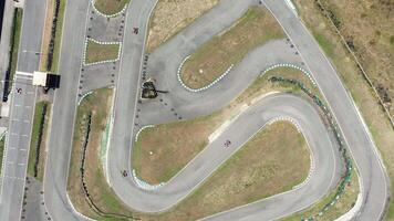 Aerial shot go-karts on winding race track during competition video