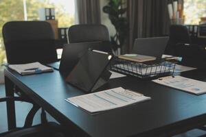 Laptop on a desk in an open financial office. photo