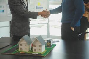 Team of architectures and businessmen discussing and brainstorming on floor plan modification for real estate investment and housing development project photo