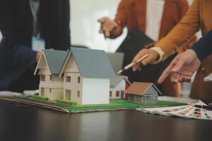 Team of architectures and businessmen discussing and brainstorming on floor plan modification for real estate investment and housing development project photo