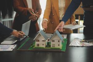 Team of architectures and businessmen discussing and brainstorming on floor plan modification for real estate investment and housing development project photo