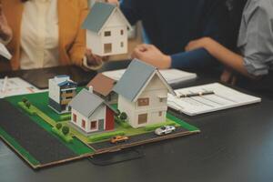 Team of architectures and businessmen discussing and brainstorming on floor plan modification for real estate investment and housing development project photo