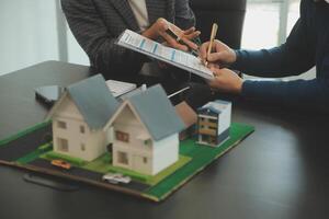 Team of architectures and businessmen discussing and brainstorming on floor plan modification for real estate investment and housing development project photo