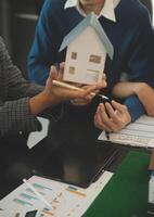 Team of architectures and businessmen discussing and brainstorming on floor plan modification for real estate investment and housing development project photo