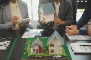 Team of architectures and businessmen discussing and brainstorming on floor plan modification for real estate investment and housing development project photo