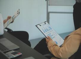 Business team collaboration discussing working analyzing with financial data and marketing growth report graph in team, presentation and brainstorming to strategy planning making profit of company. photo