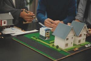 Team of architectures and businessmen discussing and brainstorming on floor plan modification for real estate investment and housing development project photo