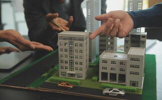 Team of architectures and businessmen discussing and brainstorming on floor plan modification for real estate investment and housing development project photo