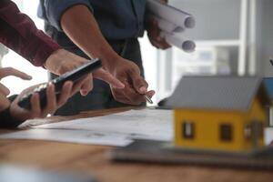 Diverse Team of Specialists Use Laptop on Construction Site. Real Estate Building Project with Engineer Investor and Businessman Checking Area, working on Civil Engineering, Discussing Strategy Plan photo