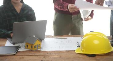 Diverse Team of Specialists Use Laptop on Construction Site. Real Estate Building Project with Engineer Investor and Businessman Checking Area, working on Civil Engineering, Discussing Strategy Plan photo