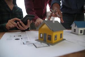 Diverse Team of Specialists Use Laptop on Construction Site. Real Estate Building Project with Engineer Investor and Businessman Checking Area, working on Civil Engineering, Discussing Strategy Plan photo