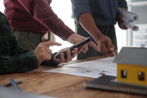 Diverse Team of Specialists Use Laptop on Construction Site. Real Estate Building Project with Engineer Investor and Businessman Checking Area, working on Civil Engineering, Discussing Strategy Plan photo