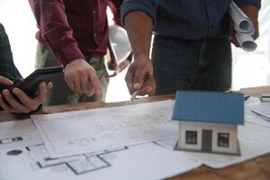 Diverse Team of Specialists Use Laptop on Construction Site. Real Estate Building Project with Engineer Investor and Businessman Checking Area, working on Civil Engineering, Discussing Strategy Plan photo