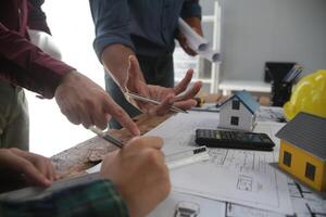 Diverse Team of Specialists Use Laptop on Construction Site. Real Estate Building Project with Engineer Investor and Businessman Checking Area, working on Civil Engineering, Discussing Strategy Plan photo