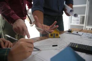 Diverse Team of Specialists Use Laptop on Construction Site. Real Estate Building Project with Engineer Investor and Businessman Checking Area, working on Civil Engineering, Discussing Strategy Plan photo