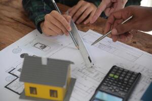 Diverse Team of Specialists Use Laptop on Construction Site. Real Estate Building Project with Engineer Investor and Businessman Checking Area, working on Civil Engineering, Discussing Strategy Plan photo