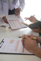 Medical Team Meeting Around Table In Modern Hospital photo
