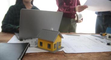 Diverse Team of Specialists Use Laptop on Construction Site. Real Estate Building Project with Engineer Investor and Businessman Checking Area, working on Civil Engineering, Discussing Strategy Plan photo