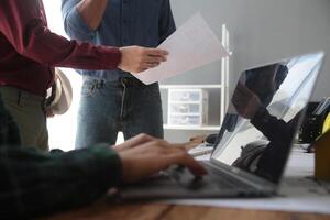 Diverse Team of Specialists Use Laptop on Construction Site. Real Estate Building Project with Engineer Investor and Businessman Checking Area, working on Civil Engineering, Discussing Strategy Plan photo