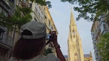 Woman taking picture of cathedral video