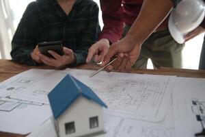 Diverse Team of Specialists Use Laptop on Construction Site. Real Estate Building Project with Engineer Investor and Businessman Checking Area, working on Civil Engineering, Discussing Strategy Plan photo