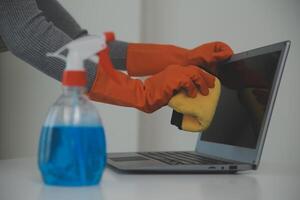 Woman cleaning table using rag and diffuser at home. photo