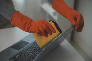 Woman cleaning table using rag and diffuser at home. photo