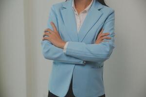 Young business arab woman isolated against a white background who feels confident, crossing arms with determination. photo