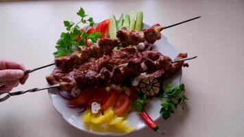 Shish kebab with mushrooms, cherry tomato and sweet pepper, Grilled meat skewers. Top view, copyspace. most important meat dish of Turkish cuisine kebabs is a rich product that is cooked on embers video
