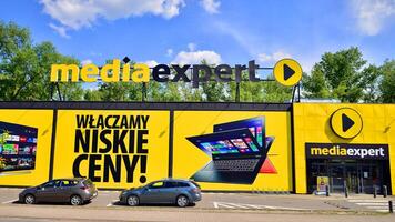 Warsaw, Poland. 28 April 2024. Media Expert shop with logo sign. Polish chain of supermarkets with electronics, appliances, computers, software and multimedia. Electromarket store signboard. photo