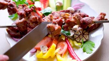 The cook removes the kebab from the skewer on a wooden board.4K footage. Great for editing, color grading and grading. Vertical . video