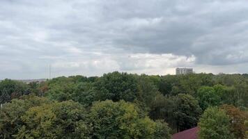 filming a from a Ferris wheel in the city of Vinnitsa, Ukraine old attractions view of the city Tall iron wheel in the park colorful baskets green trees rainy sky video