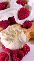 Waffles with cream and raspberries Close-up side view Belgian waffles with cream and strawberries on breakfast. High quality 4k footage video