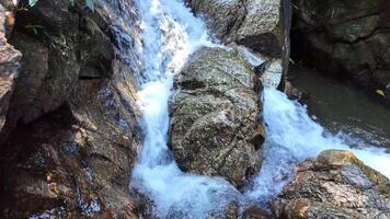 sprudelnd Berg Wasserfall Über robust Felsen, symbolisieren natürlich Schönheit und Erde Tag Erhaltung Bemühungen video