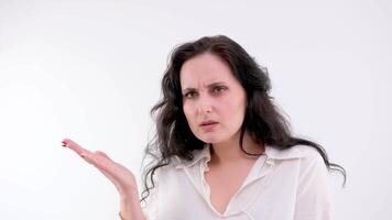 An angry, disgruntled woman. She looks straight ahead, white background video
