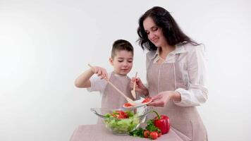 mom and little son spread on cheese honey breakfast healthy food on a white background drink tea kitchen apron video