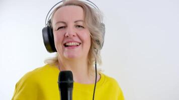 beautiful stylish woman singing karaoke isolated over white background. video