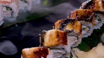 delicious restaurant asian food sushi on plate with dry ice eel tuna set enveloping all around space for text advertising sushi serving menu chef courses sushi maker close-up incredibly delicious video