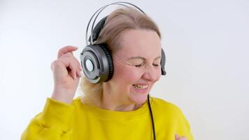 kvinna med hörlurar lyssnar till musik isolerat på blå bakgrund. fest, musik, livsstil, radio och disko begrepp. kopia Plats. video