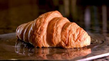 vers gebakken croissants dichtbij omhoog macro visie. Frans croissants roterend Aan een zwart achtergrond. vers en smakelijk Frans ontbijt. video