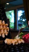 Belgian waffles in a white plate on a light wooden background. Waffles without filling. video