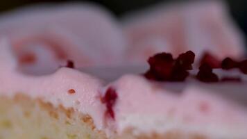 macro panorama down on small group of pink marshmallow cookies decorated with violet and white flowers video