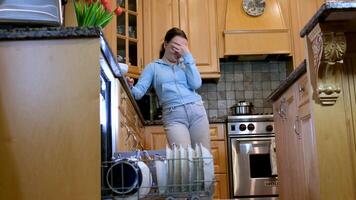 loading the dishwasher cleaning the house unpacking the dishes put in their places boys girl teenagers in the kitchen cleaning brother and sister household chores video